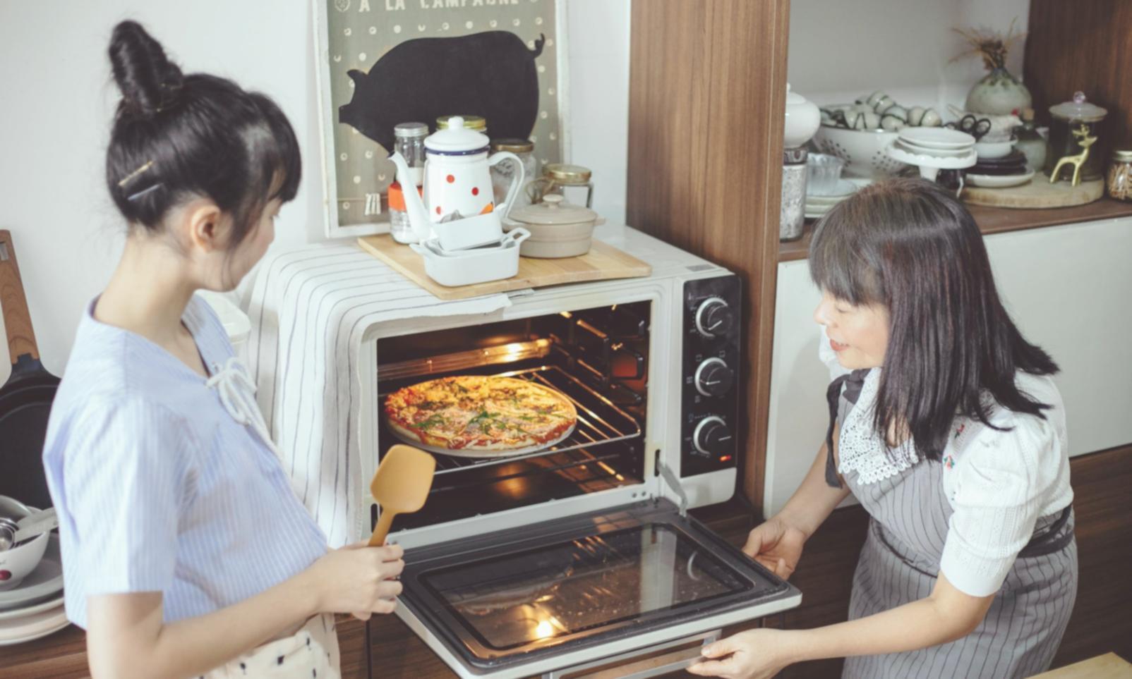 Students practicing meal prep techniques in small group setting with organized workstations
